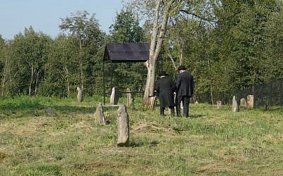 Visitors explore one of the Jewish cemeteries in Lyubavichi, August 26, 2018. (Cnaan Liphshiz)