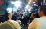 Protesters in southern Tel Aviv burn a photo of Interior Minister Aryeh Deri to protest the continued presence of tens of thousands of African asylum seekers in their impoverished neighborhoods, August 30, 2018 (Hadashot screen capture)