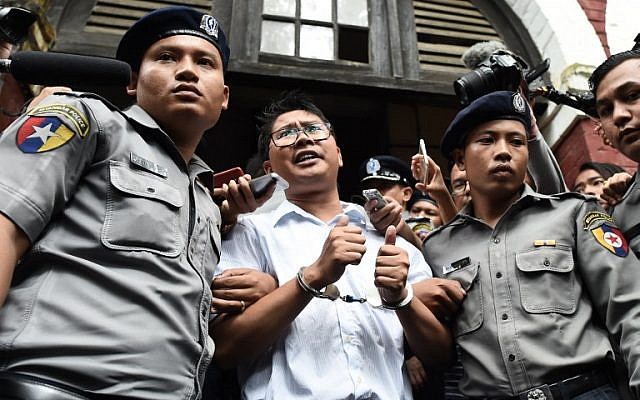 Myanmar journalist Wa Lone (C) is escorted by police after being sentenced by a court to jail in Yangon on September 3, 2018. (AFP PHOTO / Ye Aung THU) Myanmar journalist Wa Lone (C) is escorted by police after being sentenced by a court to jail in Yangon on September 3, 2018. (AFP PHOTO / Ye Aung THU)