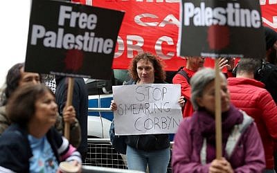 Illustrative: Demonstrators hold placards as they protest outside the headquarters of Britain's opposition Labour party in central London on September 4, 2018. (AFP PHOTO / Daniel LEAL-OLIVAS)