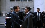President of the Central Jewish Consistory of Paris Joel Mergui (C) greets French President Emmanuel Macron (L) upon his arrival to attend a ceremony to mark the Jewish New Year - Rosh Hashanah - at The Great Synagogue in Paris on September 4, 2018. (AFP PHOTO / POOL / YOAN VALAT)