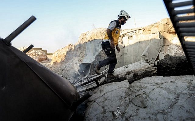 This picture taken on September 6, 2018 shows a member of the Syrian Civil Defence, also known as the "White Helmets", walking through the wreckage of their center which was destroyed by government forces' bombardment in the town of al-Tamana on the southern edges of the rebel-held Idlib province.
(AFP OMAR HAJ KADOUR) This picture taken on September 6, 2018 shows a member of the Syrian Civil Defence, also known as the "White Helmets", walking through the wreckage of their center which was destroyed by government forces' bombardment in the town of al-Tamana on the southern edges of the rebel-held Idlib province.
(AFP OMAR HAJ KADOUR)