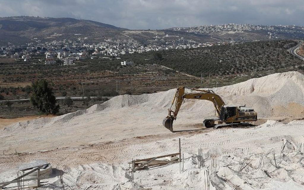 A crane is used at the construction site in the West Bank settlement of Amichai on September 7, 2018. (AFP/Thomas Coex) A crane is used at the construction site in the West Bank settlement of Amichai on September 7, 2018. (AFP/Thomas Coex)