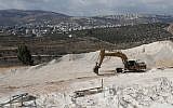 A crane is used at the construction site in the West Bank settlement of Amichai on September 7, 2018. (AFP/Thomas Coex)