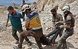 This picture taken in Kafr Ain on September 7, 2018, shows members of the Syrian Civil Defence, also known as the 'White Helmets,' carrying a victim after airstrikes, four kilometers east of Khan Shaykhun in the southern countryside of Idlib province (AFP PHOTO / Anas AL-DYAB)