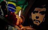 Supporters of Brazilian right-wing presidential candidate Jair Bolsonaro, light candles in the front of the Albert Einstein Hospital in Sao Paulo, where he was admitted on September 7, 2018, after being stabbed while campaigning in Juiz de Fora, Minas Gerais State.
(AFP PHOTO / Miguel SCHINCARIOL)