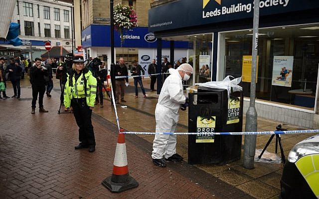A police forensics officer looks for evidence inside a cordon in Peel Square, following a stabbing incident in the centre of Barnsley, northern England on September 8, 2018. (AFP PHOTO / Oli SCARFF) A police forensics officer looks for evidence inside a cordon in Peel Square, following a stabbing incident in the centre of Barnsley, northern England on September 8, 2018. (AFP PHOTO / Oli SCARFF)