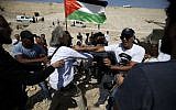 Israeli security forces scuffle with American-French protester Frank Romano on September 14, 2018, during a protest against the expected demolition of the Bedouin village of Khan al-Ahmar in the West Bank. (AFP/Abbas Momani)