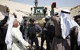 Palestinian protesters chant slogans and confront Israeli forces on September 14, 2018, as they demonstrate against the blocking of the road leading to the Palestinian Bedouin village of Khan al-Ahmar in the West Bank. (AFP PHOTO / ABBAS MOMANI)