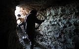 A man uses a pickaxe to dig a cave in the Syrian village of Kafr Ain in the southern countryside of the rebel-held Idlib province on September 15, 2018. (AFP /OMAR HAJ KADOUR)