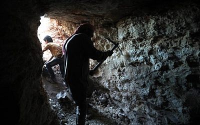 A man uses a pickaxe to dig a cave in the Syrian village of Kafr Ain in the southern countryside of the rebel-held Idlib province on September 15, 2018. (AFP /OMAR HAJ KADOUR)