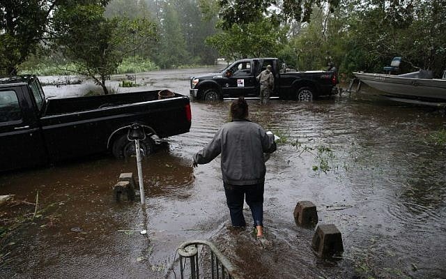 A resident walks from her flooded house towards the crew of the Cajun Navy in Lumberton, North Carolina, on September 15, 2018 in the wake of Hurricane Florence.
(AFP /Alex EDELMAN) A resident walks from her flooded house towards the crew of the Cajun Navy in Lumberton, North Carolina, on September 15, 2018 in the wake of Hurricane Florence.
(AFP /Alex EDELMAN)