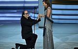 Glenn Weiss (L), winner of the Outstanding Directing for a Variety Special award for 'The Oscars,' proposes marriage to Jan Svendsen onstage during the 70th Emmy Awards at the Microsoft Theatre in Los Angeles, California on September 17, 2018. (AFP/Robyn Beck)