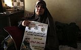 The mother of 24-year-old Palestinian Muhammad Zaghloul Khatib sits at the family's home in the West Bank village of Bayt Rima, north of Ramallah, on September 18, 2018. (AFP Photo/Abbas Momani)