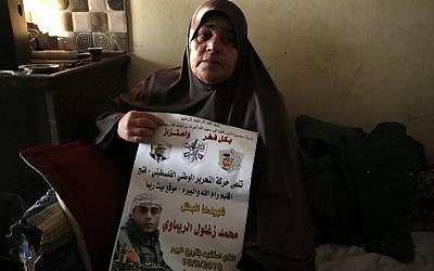 The mother of 24-year-old Palestinian Muhammad Zaghloul Khatib sits at the family's home in the West Bank village of Bayt Rima, north of Ramallah, on September 18, 2018. (AFP Photo/Abbas Momani)