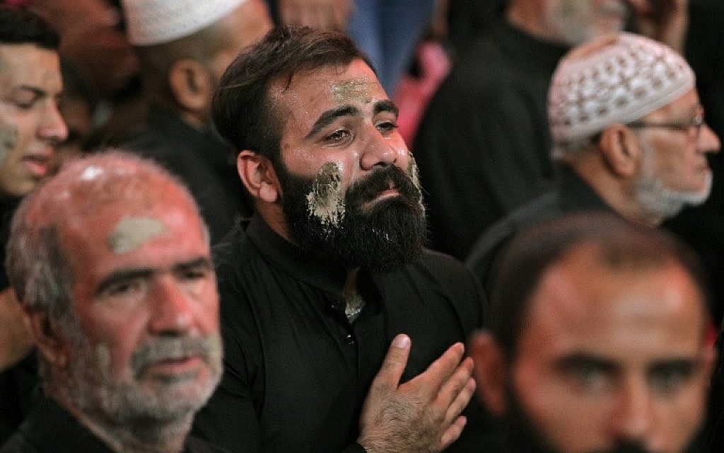 Shiite pilgrims take part in a ceremony during the ten-day mourning period leading up to Ashura, on September 19, 2018 in Iraq's holy city of Karbala.(AFP PHOTO / AHMAD AL-RUBAYE)