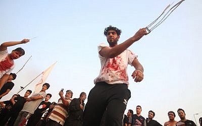 Shiite Muslims flagellate themselves as they mark Ashura, on September 20, 2018 in Iraq's southern city of Basra.(AFP PHOTO / Haidar MOHAMMED ALI)