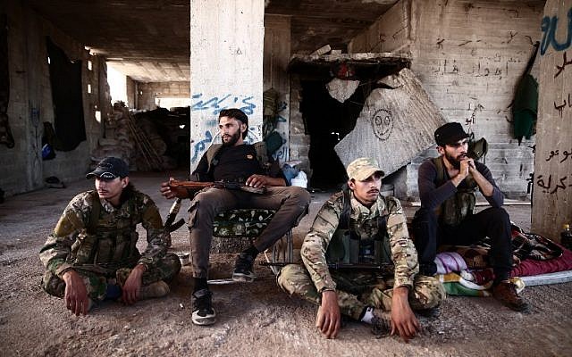 Fighters from the Nureddine al-Zinki unit, a moderate Syrian opposition faction affiliated with the Muslim Brotherhood and made up of former Syrian Free Army fighters, rest in a position in a rebel-held part of Aleppo province that lies directly east of the main opposition bastion in Idlib on September 23, 2018 (AFP PHOTO / Nazeer AL-KHATIB) Fighters from the Nureddine al-Zinki unit, a moderate Syrian opposition faction affiliated with the Muslim Brotherhood and made up of former Syrian Free Army fighters, rest in a position in a rebel-held part of Aleppo province that lies directly east of the main opposition bastion in Idlib on September 23, 2018 (AFP PHOTO / Nazeer AL-KHATIB)