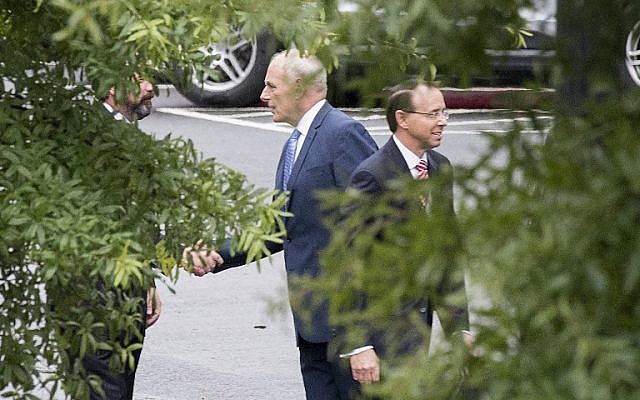 White House Chief of Staff John Kelly, center, shakes hands with an unidentified man as Assistant Attorney General Rod Rosenstein walks away after a meeting at the White House in Washington, DC, on September 24, 2018. (AFP/ Jim WATSON) White House Chief of Staff John Kelly, center, shakes hands with an unidentified man as Assistant Attorney General Rod Rosenstein walks away after a meeting at the White House in Washington, DC, on September 24, 2018. (AFP/ Jim WATSON)