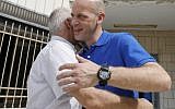 Salah Hamouri, a French-Palestinian lawyer, embraces his father Hassan at their home in the village of Dahyat al-Barid near Jerusalem in the West Bank, after being released from an Israeli prison, on September 30, 2018. (AFP/Ahmad Gharabli)