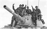 Soldiers pose on top of a tank during the outbreak of the Yom Kippur War on October 6, 1973. (Avi Simhoni/Bamahane/Defense Ministry Archives)