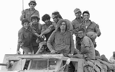 Reservist soldiers pose on the top of a truck during the outbreak of the Yom Kippur War in the Sinai Peninsula on October 6, 1973. (Avi Simhoni/Bamahane/Defense Ministry Archives)