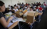 Palestinian students receive new studying books inside their classroom, during the first day of a new school year, at one of the UNRWA schools, in Beirut, Lebanon, September 3, 2018. (Hussein Malla/AP)