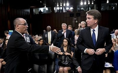 Fred Guttenberg, the father of Jamie Guttenberg who was killed in the Stoneman Douglas High School shooting in Parkland, Florida., left, attempts to shake hands with Supreme Court nominee, Brett Kavanaugh on Capitol Hill in Washington, September 4, 2018 (AP Photo/Andrew Harnik)