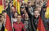 People attend a demonstration in Chemnitz, eastern Germany, on September 7, 2018, after several nationalist groups called for marches protesting the killing of a German man two weeks ago, allegedly by migrants from Syria and Iraq. (AP Photo/Jens Meyer)