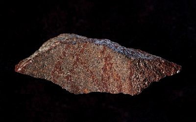 This undated photo provided by Craig Foster in September 2018 shows a drawing made with ochre pigment on silcrete stone, found in the Blombos Cave east of Cape Town, South Africa. (Craig Foster via AP)