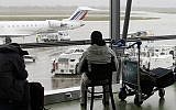 In this Dec.17, 2011 file photo, a passenger waits for his flight during at Lyon's Saint Exupery airport, central France (AP Photo/Laurent Cipriani, File)