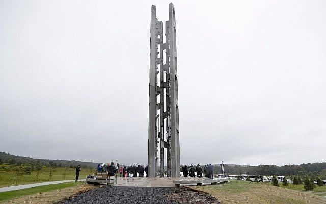 In this Sept. 9, 2018 file photo, people attending the dedication stand around the 93-foot tall Tower of Voices at the Flight 93 National Memorial in Shanksville, Pa., where the tower contains 40 wind chimes representing the 40 people that perished in the crash of Flight 93 in the terrorist attacks of Sept. 11, 2001. (AP Photo/Keith Srakocic, Pool) In this Sept. 9, 2018 file photo, people attending the dedication stand around the 93-foot tall Tower of Voices at the Flight 93 National Memorial in Shanksville, Pa., where the tower contains 40 wind chimes representing the 40 people that perished in the crash of Flight 93 in the terrorist attacks of Sept. 11, 2001. (AP Photo/Keith Srakocic, Pool)