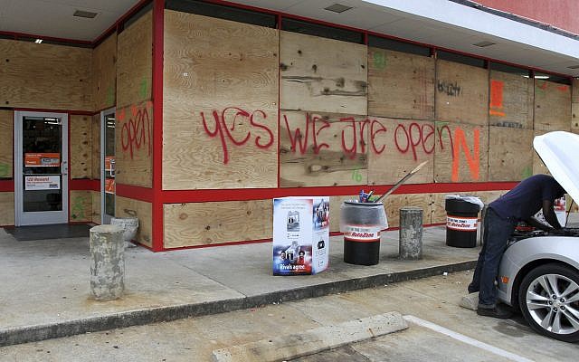 An auto parts store has wood paneling installed over the windows, Tuesday, Sept. 11, 2018, in New Bern, N.C., as a precaution against storm damage from Hurricane Florence. (Gray Whitley/Sun Journal via AP) An auto parts store has wood paneling installed over the windows, Tuesday, Sept. 11, 2018, in New Bern, N.C., as a precaution against storm damage from Hurricane Florence. (Gray Whitley/Sun Journal via AP)