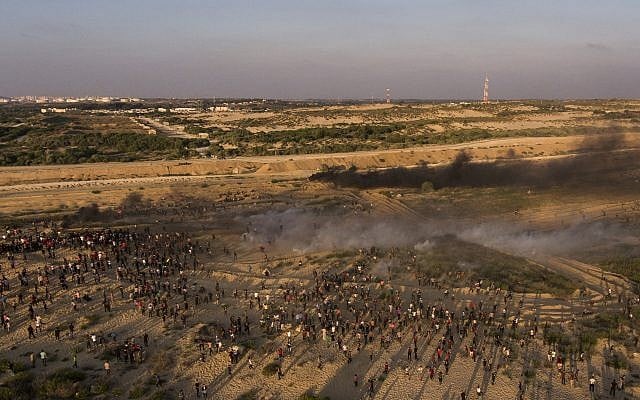 Aerial view of protesters running from teargas fired by Israeli soldiers during a protest on the beach at the border with Israel near Beit Lahiya, northern Gaza Strip, September 17, 2018. (AP/Felipe Dana) Aerial view of protesters running from teargas fired by Israeli soldiers during a protest on the beach at the border with Israel near Beit Lahiya, northern Gaza Strip, September 17, 2018. (AP/Felipe Dana)