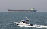 Illustrative: In this July 2, 2012, photo, an Iranian Revolutionary Guard speedboat moves in the Persian Gulf while an oil tanker is seen in the background (AP Photo/Vahid Salemi)