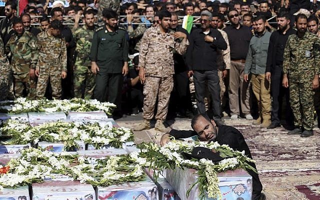 Father of Mohammad Taha Eghadami, a 4-year-old boy who was killed in Saturday's terror attack on a military parade, mourns over his coffin during a mass funeral ceremony for the victims, in southwestern city of Ahvaz, Iran, Monday, Sept. 24, 2018 (AP Photo/Ebrahim Noroozi) Father of Mohammad Taha Eghadami, a 4-year-old boy who was killed in Saturday's terror attack on a military parade, mourns over his coffin during a mass funeral ceremony for the victims, in southwestern city of Ahvaz, Iran, Monday, Sept. 24, 2018 (AP Photo/Ebrahim Noroozi)