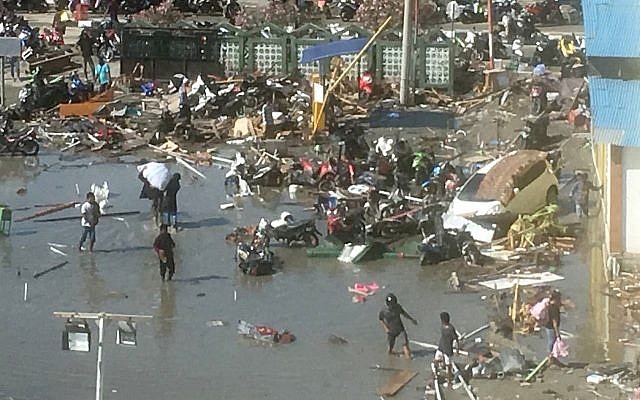 People survey the damage from earthquakes and a tsunami in Palu, Central Sulawesi, Indonesia, Sunday, Sept. 30, 2018. (AP Photo/Tatan Syuflana) People survey the damage from earthquakes and a tsunami in Palu, Central Sulawesi, Indonesia, Sunday, Sept. 30, 2018. (AP Photo/Tatan Syuflana)