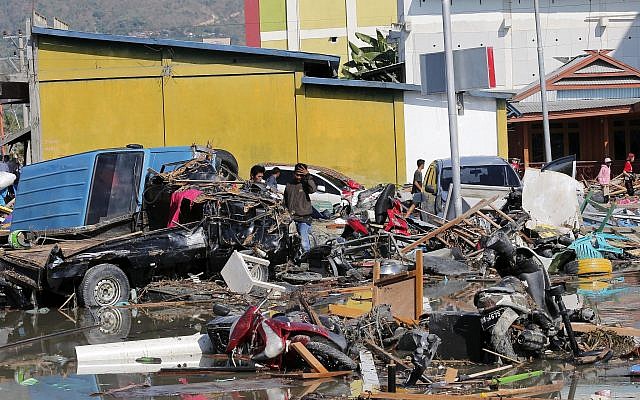People survey the damage near a shopping mall following earthquakes and a tsunami in Palu, Central Sulawesi, Indonesia, Sunday, Sept. 30, 2018. (AP Photo/Tatan Syuflana) People survey the damage near a shopping mall following earthquakes and a tsunami in Palu, Central Sulawesi, Indonesia, Sunday, Sept. 30, 2018. (AP Photo/Tatan Syuflana)