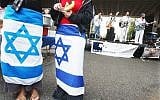 Illustrative: Two young women wear Israeli flags around their waists as a Jewish band plays at a pro-Israel gathering on the Rutgers University campus in New Brunswick, New Jersey campus, October 10, 2003. (AP Photo/Daniel Hulshizer)