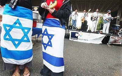 Illustrative: Two young women wear Israeli flags around their waists as a Jewish band plays at a pro-Israel gathering on the Rutgers University campus in New Brunswick, New Jersey campus, October 10, 2003. (AP Photo/Daniel Hulshizer) Illustrative: Two young women wear Israeli flags around their waists as a Jewish band plays at a pro-Israel gathering on the Rutgers University campus in New Brunswick, New Jersey campus, October 10, 2003. (AP Photo/Daniel Hulshizer)