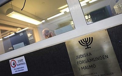 Illustrative: In this March 3, 2010 photo, a man sits behind a glassed-in reception area of the high security Jewish community center located in central Malmo, Sweden. (AP Photo/Pamela Juhl)