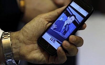 Ziad Zakka, brother of Nizar Zakka who is imprisoned in Iran, shows a photo of his brother on his cellular telephone in Beirut, Lebanon, July 18, 2017. (AP Photo/Bilal Hussein)