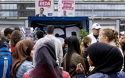 Young women listen to a party member of the right wing Sweden Democrats in Stockholm, Sweden, Friday, August 31, 2018. (AP/Michael Probst)