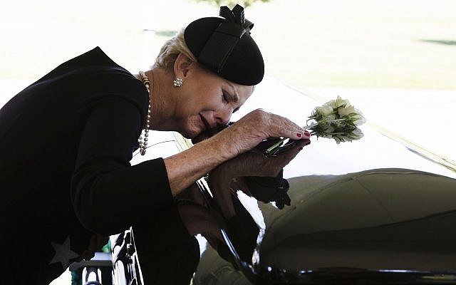 In this photo provided by the family of John McCain, Cindy McCain lays her head on the casket of Sen. John McCain, R-Ariz., during a burial service at the cemetery at the United States Naval Academy in Annapolis, Md., on Sunday, Sept. 2, 2018. (David Hume Kennerly/McCain Family via AP) In this photo provided by the family of John McCain, Cindy McCain lays her head on the casket of Sen. John McCain, R-Ariz., during a burial service at the cemetery at the United States Naval Academy in Annapolis, Md., on Sunday, Sept. 2, 2018. (David Hume Kennerly/McCain Family via AP)