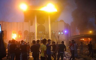 Protesters storm and burn the Iranian consulate building during anti-government protests in the southern Iraqi city of Basra on September 7, 2018. (AP/Nabil al-Jurani)