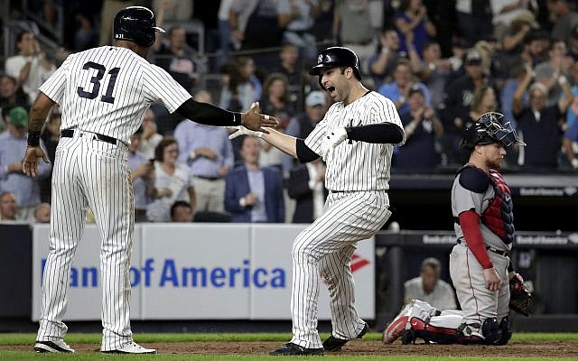 New York Yankees' Neil Walker, right, celebrates with Aaron Hicks (31) after hitting a three-run home run off Boston Red Sox relief pitcher Ryan Brasier during the seventh inning of a baseball game, Sept. 18, 2018, in New York. Red Sox catcher Christian Vazquez is at right. (AP Photo/Julio Cortez) New York Yankees' Neil Walker, right, celebrates with Aaron Hicks (31) after hitting a three-run home run off Boston Red Sox relief pitcher Ryan Brasier during the seventh inning of a baseball game, Sept. 18, 2018, in New York. Red Sox catcher Christian Vazquez is at right. (AP Photo/Julio Cortez)