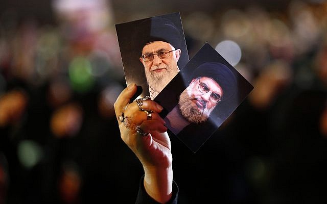 A Hezbollah supporter holds up portraits of Hezbollah leader Sheikh Hassan Nasrallah, right, and Iran's Supreme Leader Ayatollah Ali Khamenei, left, during activities to mark the ninth of Ashura, a 10-day ritual commemorating the death of Imam Hussein, in a southern suburb of Beirut, Lebanon, on September 19, 2018. (AP Photo/Hussein Malla) A Hezbollah supporter holds up portraits of Hezbollah leader Sheikh Hassan Nasrallah, right, and Iran's Supreme Leader Ayatollah Ali Khamenei, left, during activities to mark the ninth of Ashura, a 10-day ritual commemorating the death of Imam Hussein, in a southern suburb of Beirut, Lebanon, on September 19, 2018. (AP Photo/Hussein Malla)