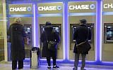 Customers using ATM machines at a branch of Chase Bank in New York, January 14, 2015. (AP/Mark Lennihan)
