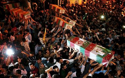 Illustrative image: Iranian mourners carry flag-draped coffins of soldiers killed during the Iran-Iraq war in the 1980s, in Tehran, Iran, June 16, 2015. (AP Photo/Ebrahim Noroozi)