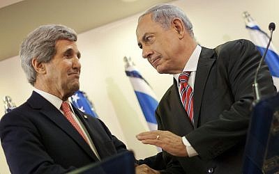 U.S. Secretary of State John Kerry, left, and Israeli Prime Minister Benjamin Netanyahu shakes hands during their joint statement at the prime minister's office in Jerusalem, Thursday, Dec. 5, 2013. (AP Photo/Pablo Martinez Monsivais, Pool)